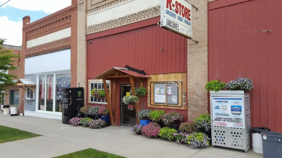 K-Store rural grocery distribution center with propane delivery, featuring storefront entrance and AmeriGas fuel station for wholesale food supply ope